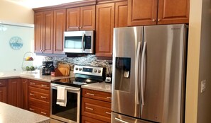 Enjoy cooking in this fully equipped kitchen with a microwave, oven, and refrigerator.