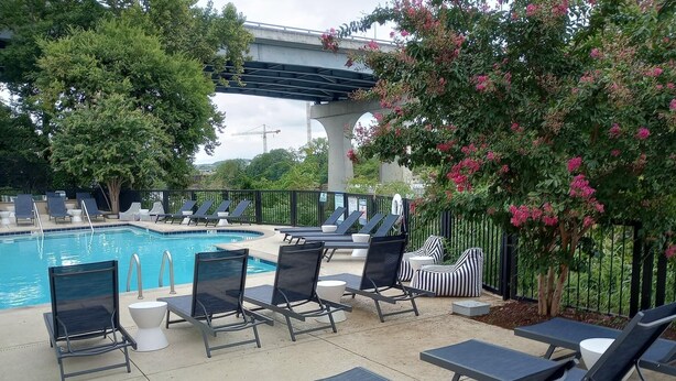 A poolside area with lounge chairs and a swimming pool.