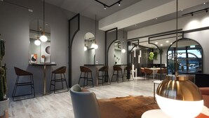 A modern interior with a bar area, seating, and large mirrors. - Light Year (Ji'an)