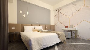A modern bedroom with a large bed, bedside tables, a desk, and a marble-patterned wall. - Light Year (Ji'an)