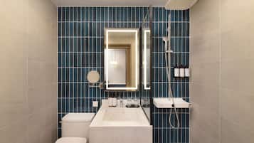 Une salle de bain moderne avec une grande baignoire, des toilettes et un espace douche.