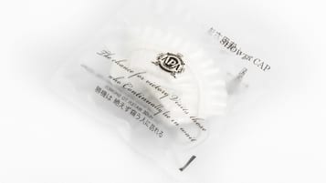 A white pillow with text and a logo.