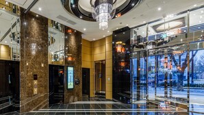 A modern hotel lobby with a grand chandelier, marble walls, and a glass entrance. - APA Hotel Hakata Gion Ekimae (Fukuoka)