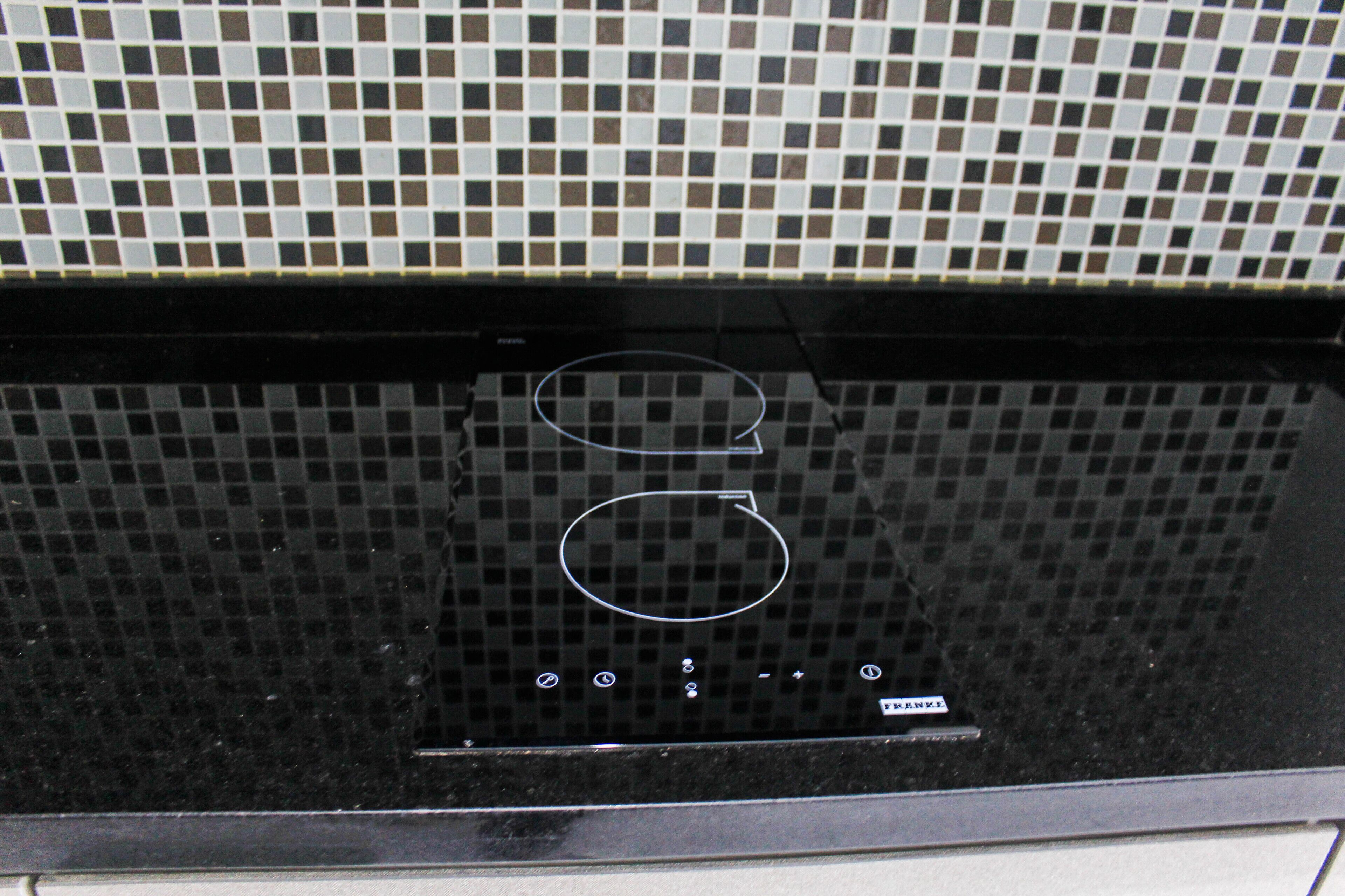 A black control panel with a grid of buttons and a label that reads "FANX".