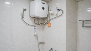 A modern bathroom with a built-in shower unit, a handheld showerhead, and a handheld shower attachment. - Best And Relax Studio Room Parkland Avenue Apartment (South Tangerang)
