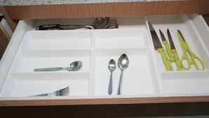 A drawer with compartments containing various utensils like forks, spoons, and knives. - Best And Relax Studio Room Parkland Avenue Apartment (South Tangerang)