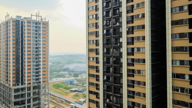 A high-rise building with multiple floors, large windows, and balconies. - Cozy 2Br At Meikarta Apartment (Cikarang)