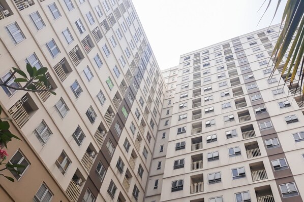 A multi-story residential building with balconies and windows.