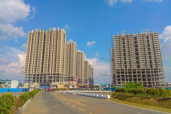 A multi-story building with a modern architectural design, featuring a series of balconies and large windows.
