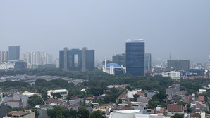 A cityscape with various buildings, including high-rise structures and smaller residential buildings. - Scenic And Strategic Studio Amethyst Apartment (Jakarta)