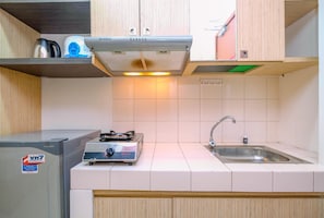 Room | Private kitchen | Fridge, stovetop, cookware/dishes/utensils - Homey And Simply Studio Room At Margonda Residence 3 Apartment (Depok)