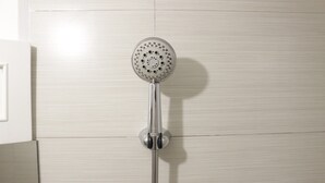 A showerhead mounted on a wall with a horizontal handle. - Elegant & Stylish Studio At Gateway Pasteur Apartment (Cimahi)