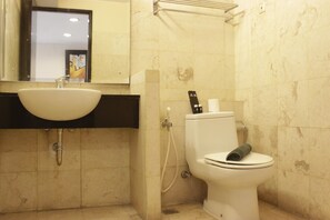 A bathroom with a sink, toilet, and shower. - Gorgeous & Comfy 2Br At Braga City Walk Apartment (Bandung)