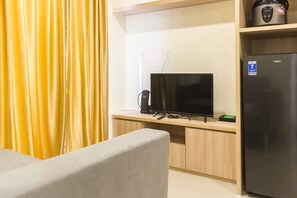 Enjoy a comfortable stay with a flat-screen TV, compact kitchen, and sofa in this stylish room.