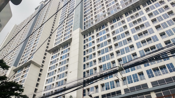 A high-rise building with multiple floors, each featuring balconies and a uniform architectural style. - Cozy And Simply Studio Tifolia Apartment Near Kelapa Gading By Travelio (Jakarta)