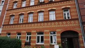 A red brick building with multiple windows and a door. - Poldi 3 - Apartments Poldi (Erfurt)
