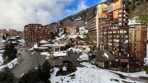 A snow-covered town with multi-story buildings, including a pharmacy and a restaurant. - Renovated apartment for 4 in Avoriaz with wifi (Avoriaz)