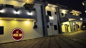 A modern building with a logo labeled "MOZ One Executive Guest Rooms" on the wall. - Moz One Executive Guest Rooms Hombori (Abuja)