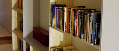 A row of wooden bookshelves filled with books, some with visible titles.
