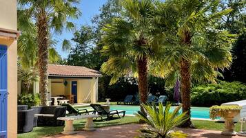 Outdoor pool, a heated pool, open 10:00 AM to 9:00 PM, pool umbrellas