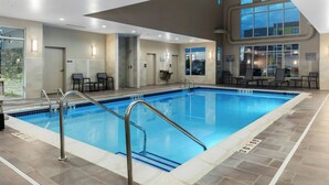 An indoor swimming pool with clear lane markings, a changing room area, and a view of the outside through large windows. - Residence Inn by Marriott Detroit Sterling Heights (Clinton Township)