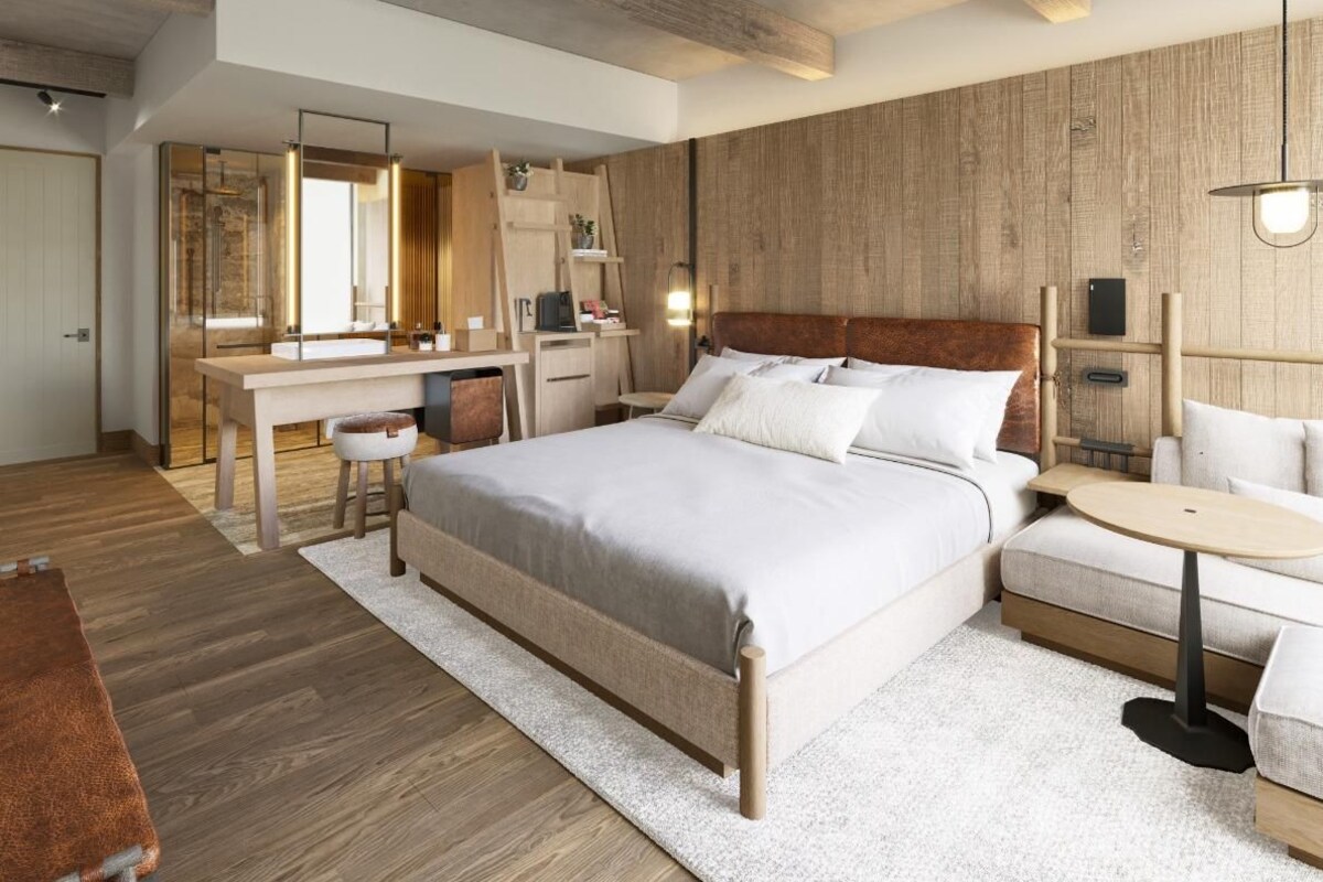 Une chambre moderne avec un grand lit, des tables de chevet, un bureau et une armoire.