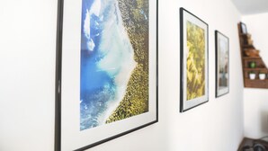 Framed artwork on a wall, including a beach scene and a forest. - Modern, cozy & central - kitchen, parking space, Netflix & more (Pfaffenhofen an der Ilm)