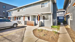 A two-story residential building with a garage, a covered patio, and a small garden area. - City Park - Walk to Main Street - Old Town (Park City)