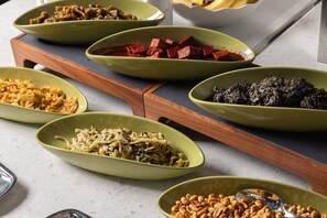 A variety of dishes on a wooden serving board. - Element Xiamen Tong'an (Xiamen)