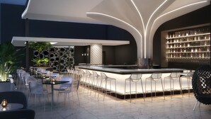 A modern bar area with a unique ceiling design, bar stools, and a well-stocked liquor shelf. -  AC Hotel by Marriott Miami Brickell (Miami)