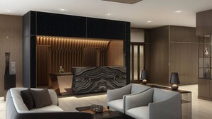A modern interior with a sectional sofa, a marble accent wall, and a sleek console table. -  AC Hotel by Marriott Miami Brickell (Miami)
