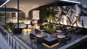 A modern outdoor lounge area with seating, a bar, and a large wall mural. -  AC Hotel by Marriott Miami Brickell (Miami)