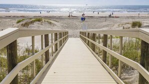 A wooden boardwalk leading to a beach with a clear view of the ocean. - Anastasia Condos Oceanfront – Spectacular Views & Great Rates! (Saint Augustine)