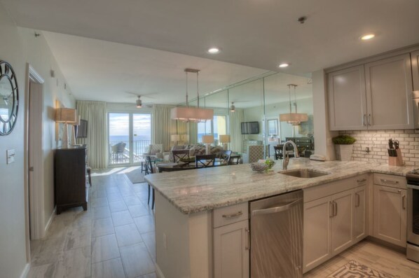 A spacious kitchen with a large island, modern appliances, and a dining area with a view.