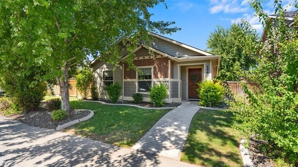 A residential house with a front yard, a driveway, and a mailbox. - Stylish Meridian Retreat Near The Village | 3BR Family Stay w/ Patio (Meridian)