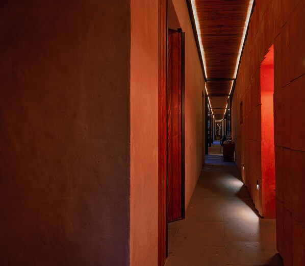 A corridor with wooden paneling and a warm, ambient light.