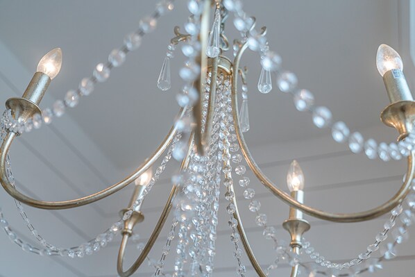 A chandelier with multiple arms and crystal decorations.