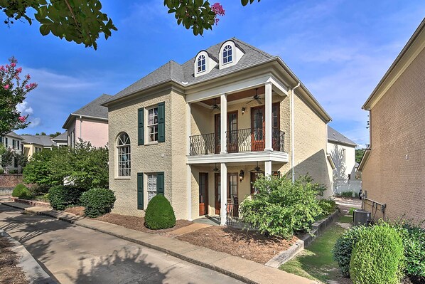 A two-story house with a balcony, a front porch, and a small front yard with landscaping. - Hector's Hotty Toddy: 2 Mi to Ole Miss (Oxford)