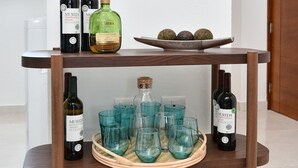 A wooden table with wine bottles and glasses. - espectacular apartamento (Playa Juan Dolio)