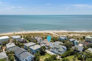 Une zone résidentielle côtière avec des maisons, une plage et l’océan.