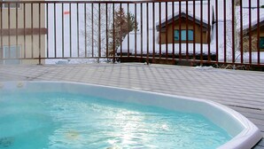A swimming pool with a wooden deck and metal railing. - Hike In/Out w/Unforgettable Views+ Hot Tub-W/D in Unit-Mini Arcade-Fireplace-Deck (Steamboat Springs)
