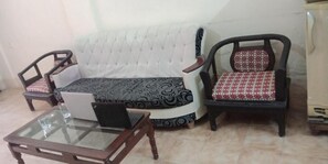 Habitación triple Deluxe | Sala de estar | Televisión LED de 32 pulgadas con canales por cable, una televisión