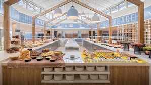 A spacious food court with multiple seating areas and a variety of food options.