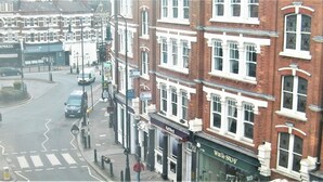 A street view with a row of red brick buildings, a 'To Let' sign, and a 'White Stuff' shop. - Unlisted
No longer accepting bookings (London)