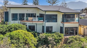 A modern two-story house with large windows and a balcony. - Bermi Bliss - Dickinson Avenue 7 (Bermagui)