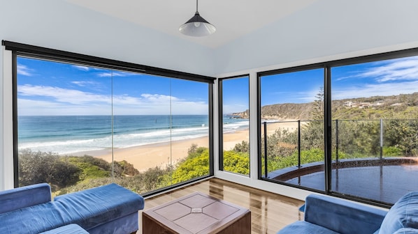 A room with large windows offering a view of the beach and ocean. - Bermi Bliss - Dickinson Avenue 7 (Bermagui)
