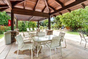 Enjoy dining and socializing in this serene outdoor patio area with a central table and comfortable seating.