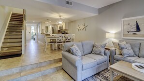 A spacious living area with a staircase, a dining area, and a kitchen. - 256 Stoney Creek - Walk to Harbour Town to watch the Pros at the Heritage! (Hilton Head Island)