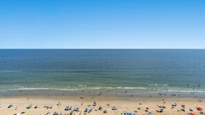 A beach with umbrellas and people. - Stunning condo with updates galore, oceanfront view | AshWorth - 1805 (North Myrtle Beach)
