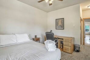 A bedroom with a bed, a desk, a chair, and a framed picture on the wall. - Nature's Oasis, 4BD Ranch Retreat, Hot tub! (Peyton)